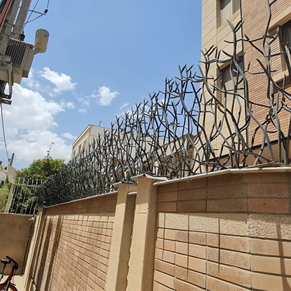 حفاظ دیوار سرنیزه ای مشهد کنار نمای آجری