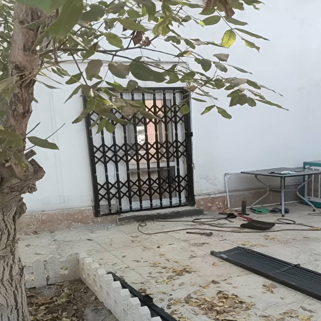 نمای نزدیک شبکه فلزی حفاظ آکاردئونی با پوشش تیره